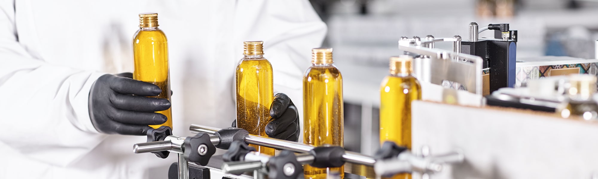 Three bottles of liquid in a personal care and cosmetics facility