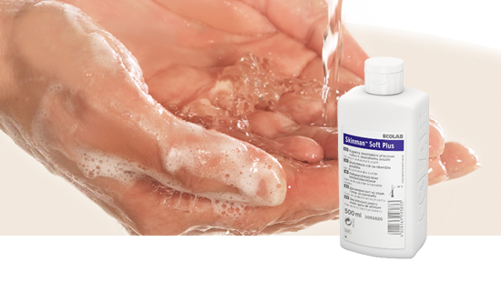 Hands being washed with soap under running water, with a bottle of Ecolab Skinman Soft Plus hand sanitizer in the foreground.