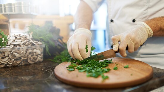 Cutting vegetables with food safety gloves