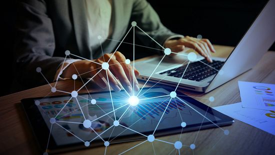 Graph overlaid on woman sitting with a laptop and pad, showing world data growth.